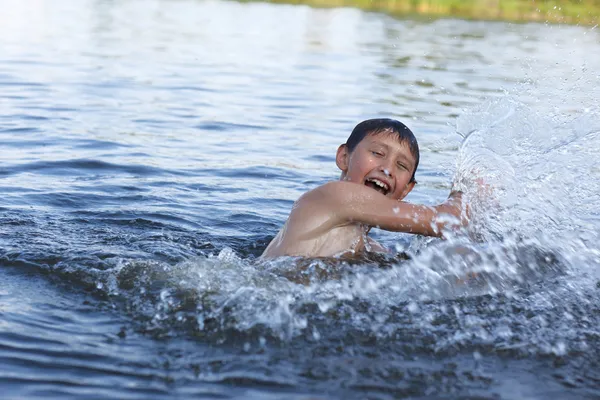 Boy in river with splash — Stock Photo, Image