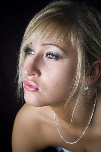 Blonde posing in studio over black background — Stock Photo, Image