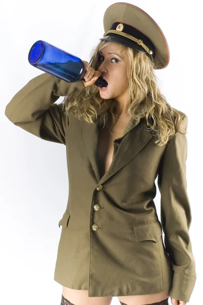 Blonde in old military form with vintage bottle — Stock Photo, Image