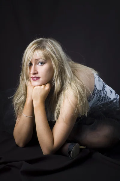 Blonde posing in studio over black background — Stock Photo, Image