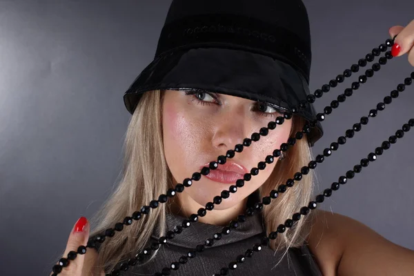 Girl in hat with black bead — Stock Photo, Image