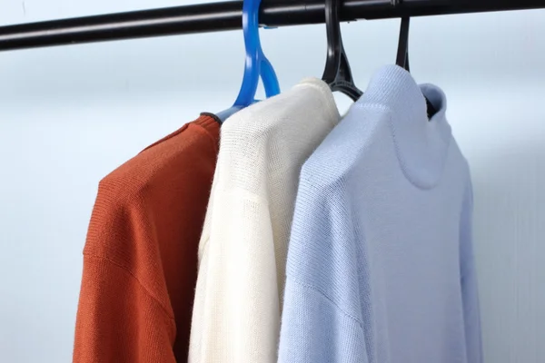 Man clothes of different colors shirt on hangers — Stock Photo, Image