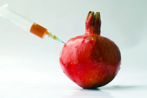 Fresh garnet with syringe — Stock Photo, Image