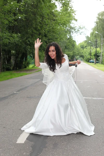 Beautiful bride on a road — Stock Photo, Image