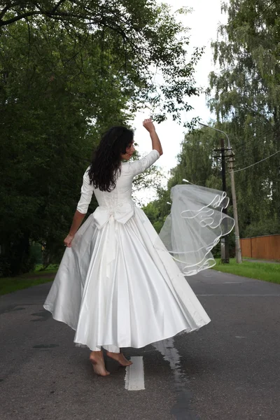 Noiva dançando em uma estrada — Fotografia de Stock