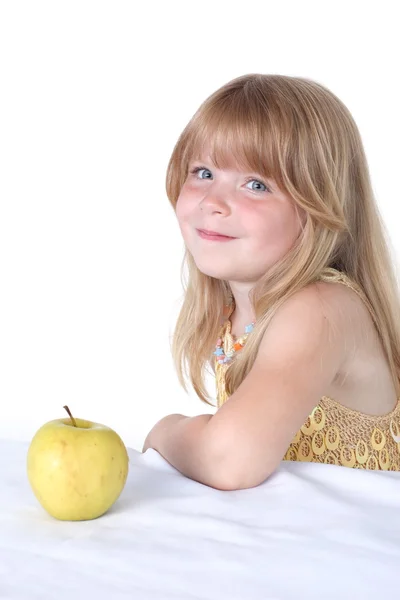 Маленькая девочка с желтым яблоком — стоковое фото