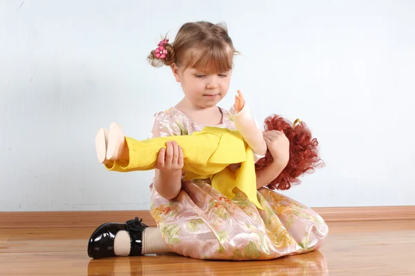 Little girl with doll in room — Stock Photo, Image