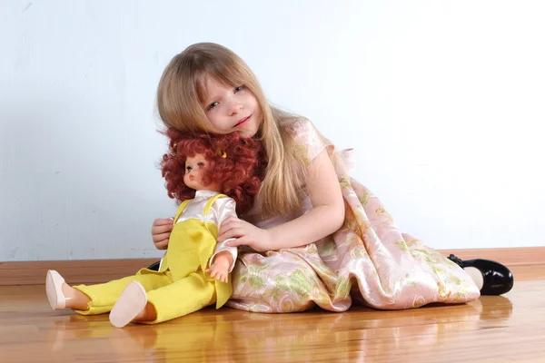 Little girl with doll in room — Stock Photo, Image