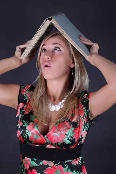 Portrait of the beautiful blonde with book on a black background — Stock Photo, Image