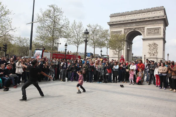 Paris - 27 april:: b-boy gör vissa breakdance rör sig framför en gatan folkmassa, arch av triumf, april 27 2013, paris, Frankrike — Stockfoto