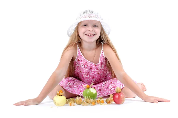Adorable little girl with apple and gooseberry (physalis) — Stock Photo, Image