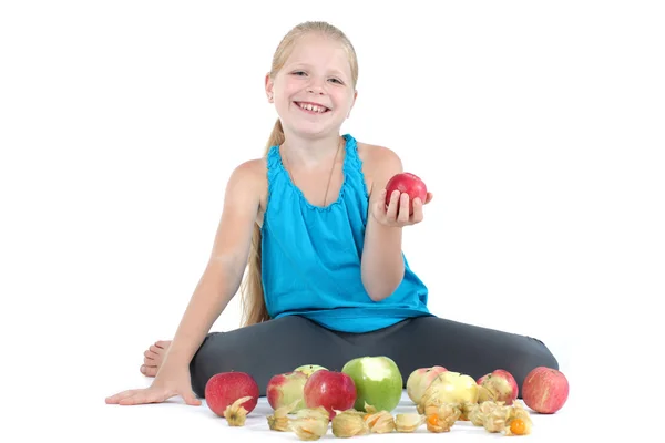 Adorable little girl with apple and gooseberry (physalis) — Stock Photo, Image