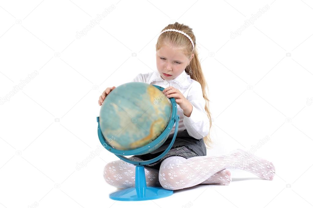 8 year old school girl with book and globe smiling on white background