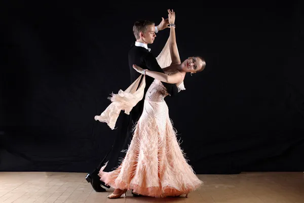 Dancers in ballroom against black background — Stock Photo, Image