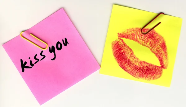 Yellow and pink sticker with the imprint of a red kiss — Stock Photo, Image