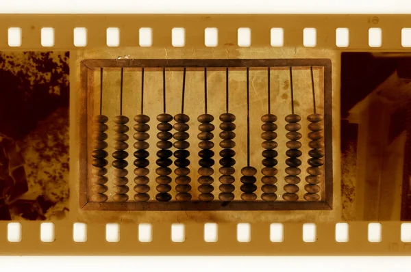 Old 35mm frame photo with vintage abacus — Stock Photo, Image