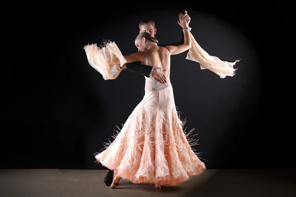 Dancers in ballroom against black background — Stock Photo, Image