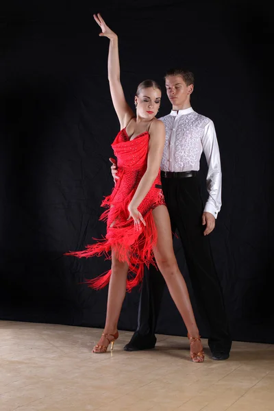 Dancers in ballroom against black background — Stock Photo, Image