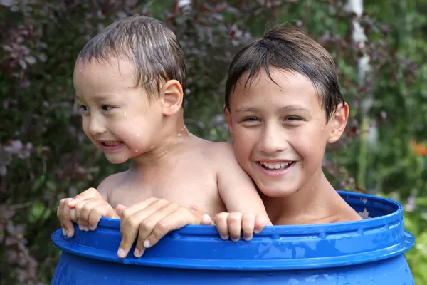 Boys in barrel of water — Stock Photo, Image