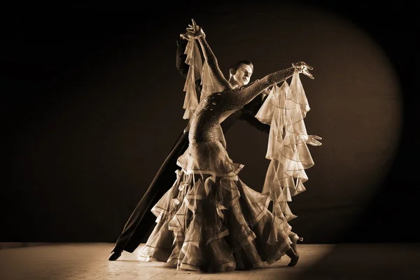 Latino dancers in ballroom against black background — Stock Photo, Image