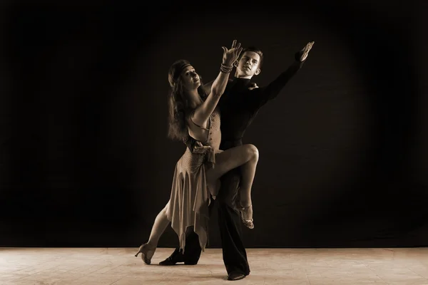 Dancers in ballroom against on black background — Stock Photo, Image