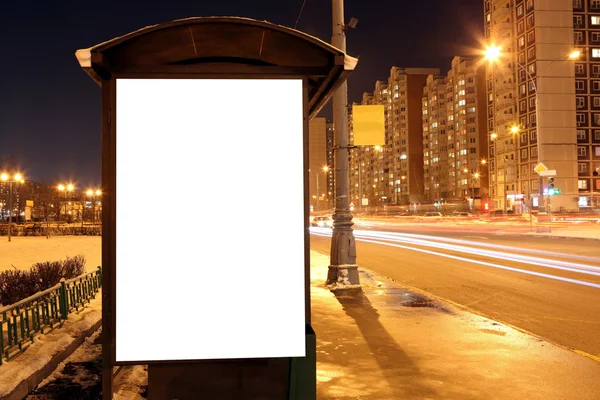 Blank sign at bus stop at evening in city — Stock Photo, Image