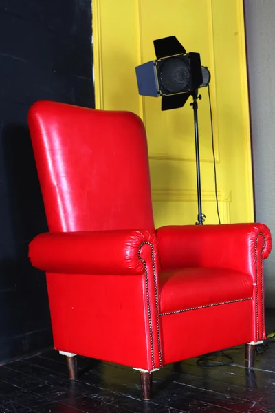 Red big armchair with studio light — Stock Photo, Image