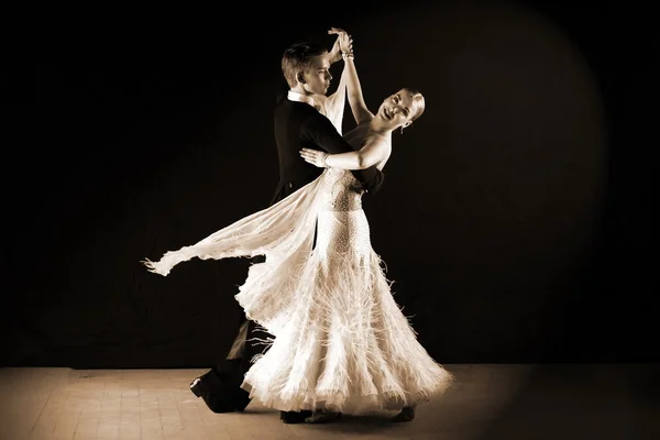 Latino dancers in ballroom against on black — Stock Photo, Image