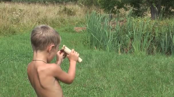 Child with a slingshot. — Stock Video