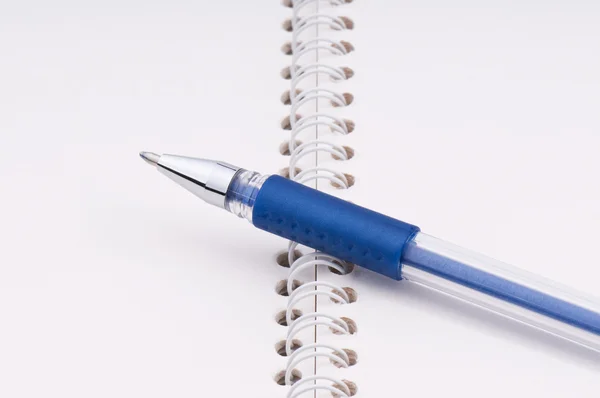 Blue ball pen on a notebook — Stock Photo, Image