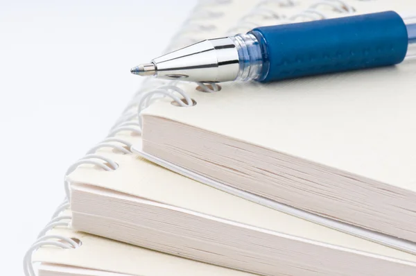 Blue ball pen on a notebook — Stock Photo, Image