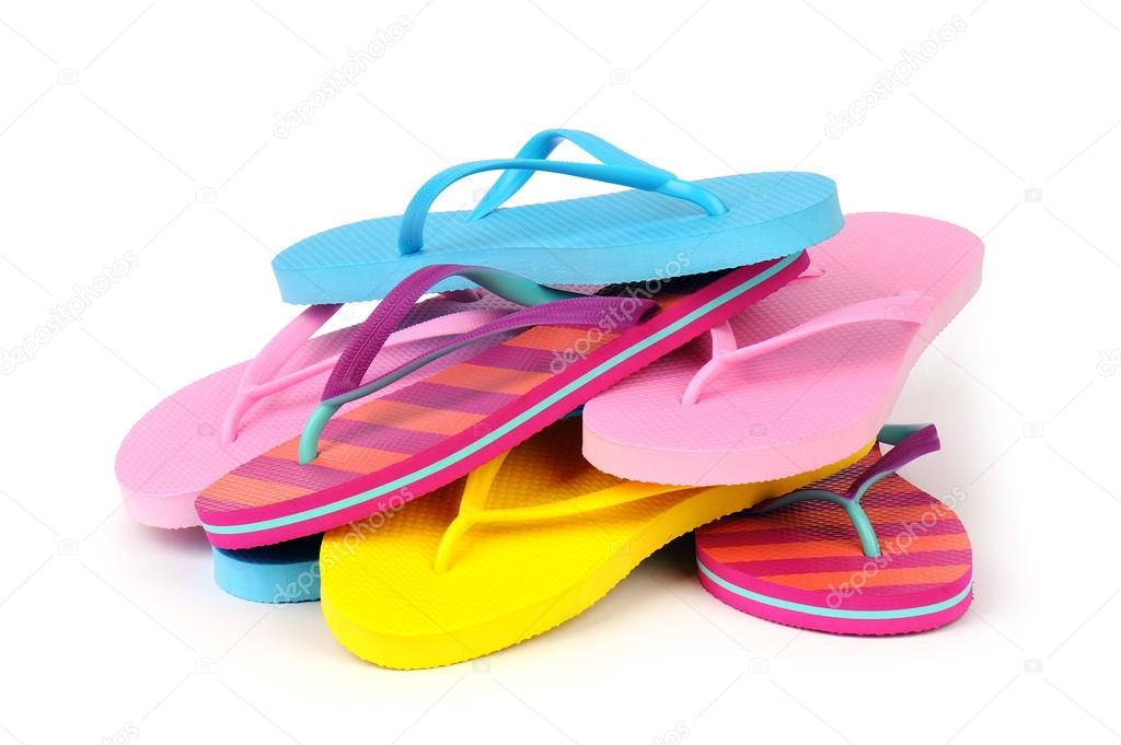 Pile of Colorful Flip Flops Isolated on White