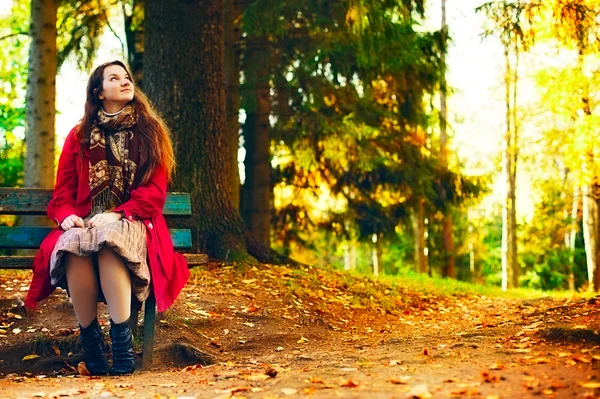 Young elegant woman  sitting on bench — Stock Photo, Image