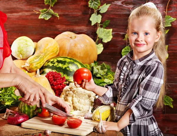 Criança com legumes na cozinha . — Fotografia de Stock
