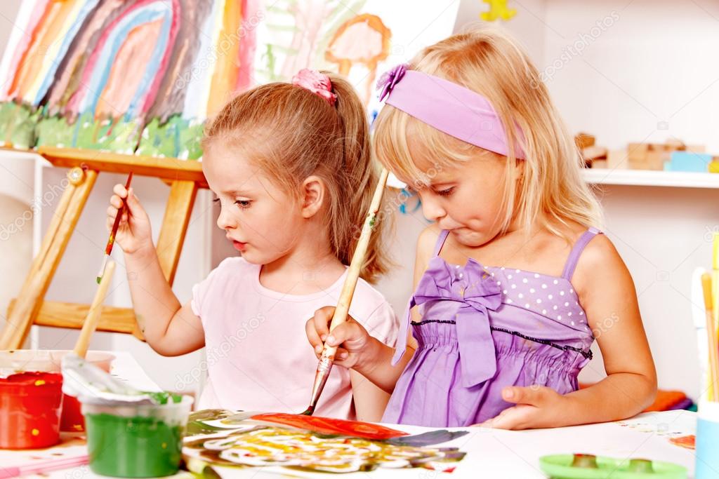 Child painting at easel. ⬇ Stock Photo, Image by © poznyakov 12071356