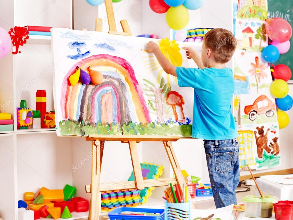 Child painting at easel.