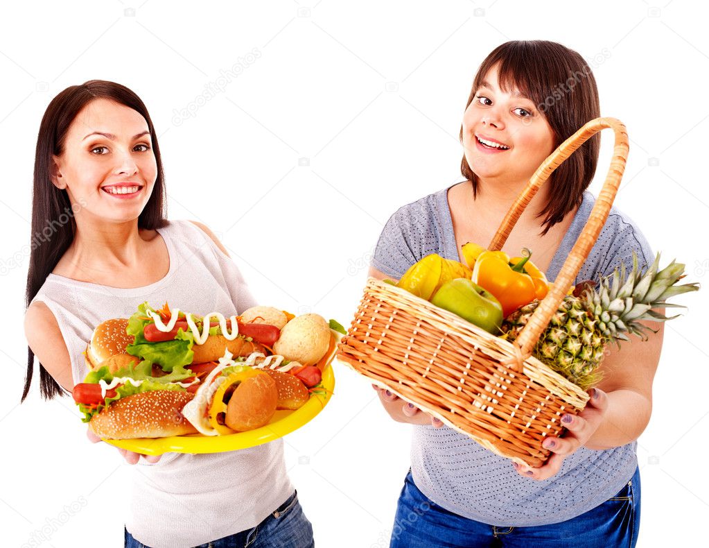Women choosing between fruit and hamburger.