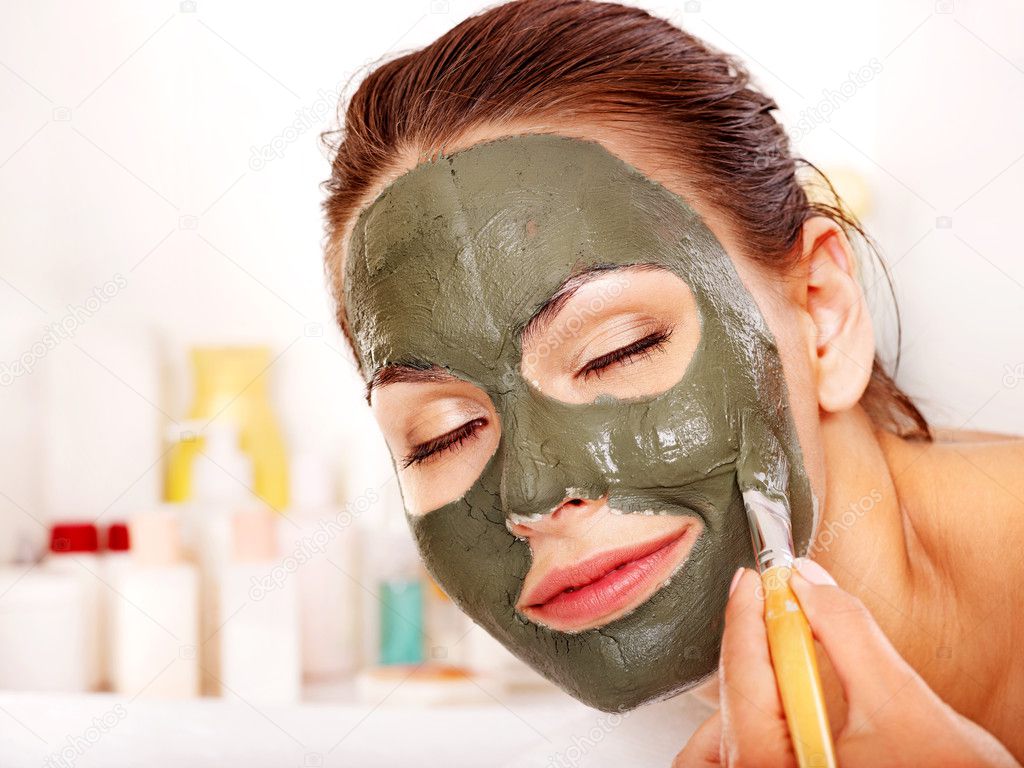 Clay facial mask in beauty spa.
