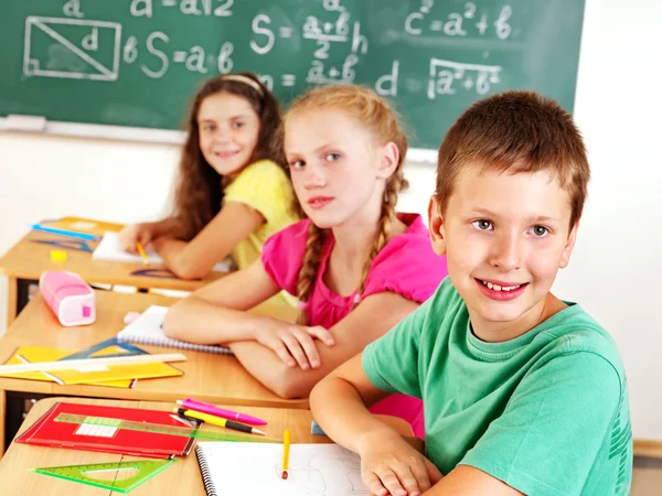 School child writting on blackboard. — Stock Photo, Image