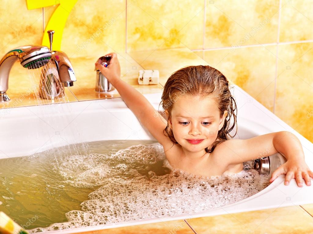 Kid washing in bath.