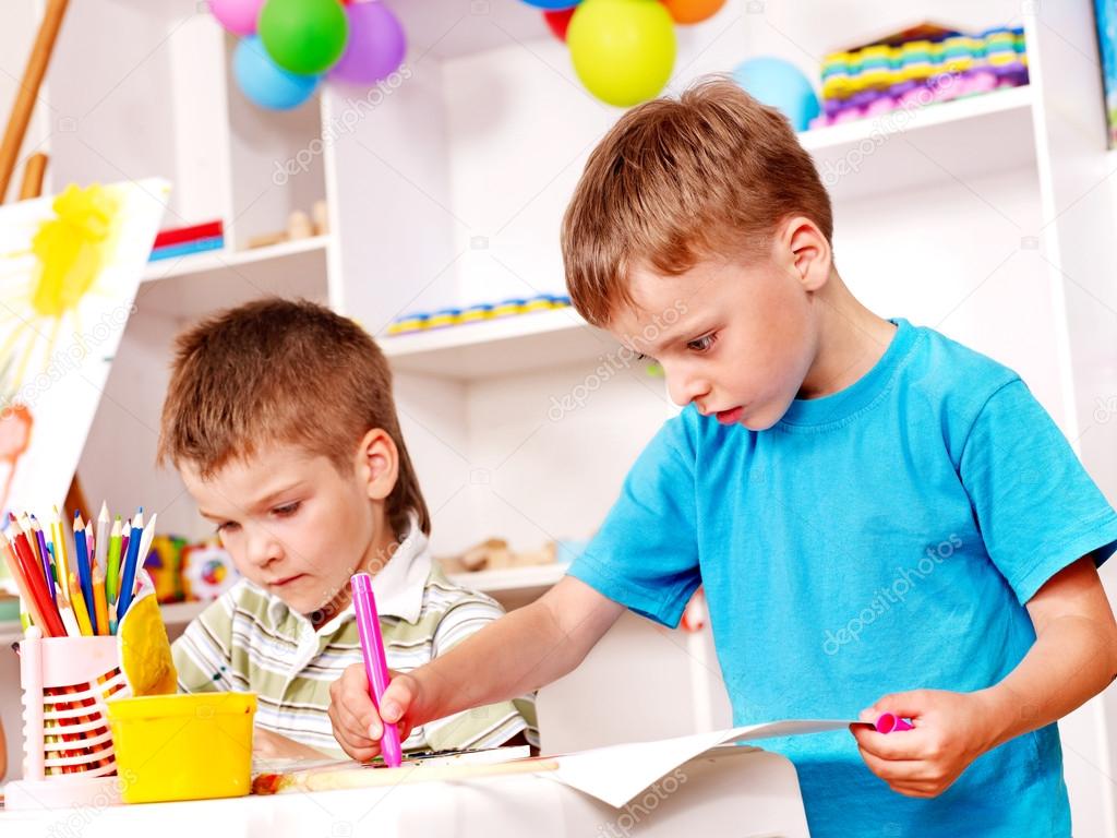 Children painting in kindergarten.