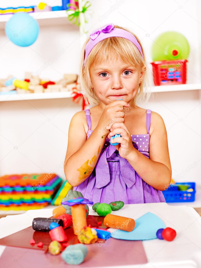 Child playing plasticine.