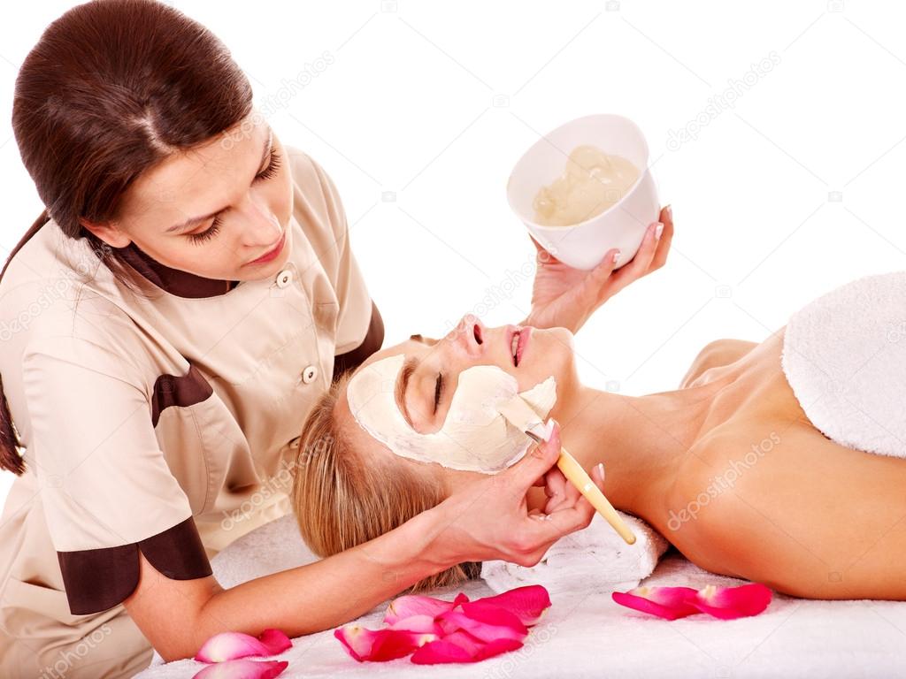 Clay facial mask in beauty spa.