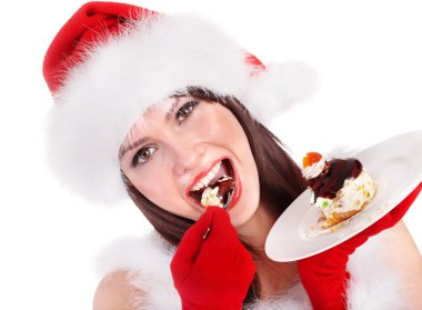 Noel Noel Baba şapkalı kız yemek pasta plaka üzerinde.