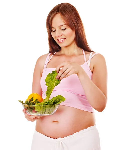 Mujer embarazada comiendo vegetales . — Foto de Stock