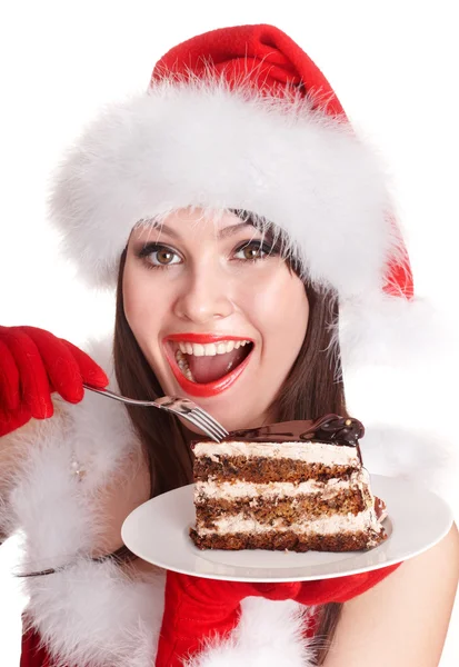 Natale ragazza in cappello di Babbo Natale mangiare torta  . — Foto Stock