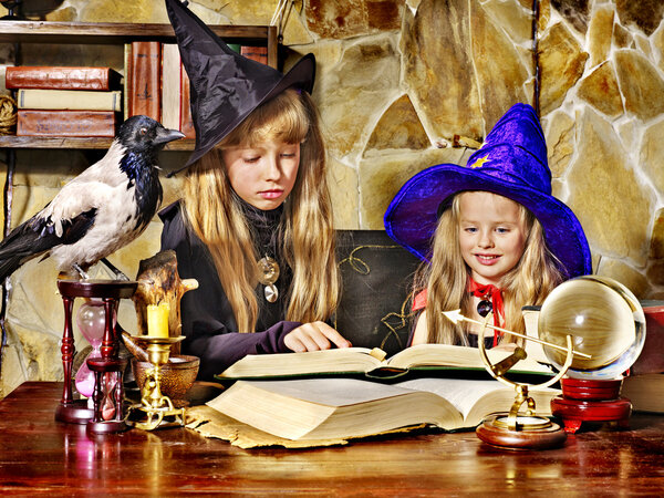 Witch children with crystal ball.