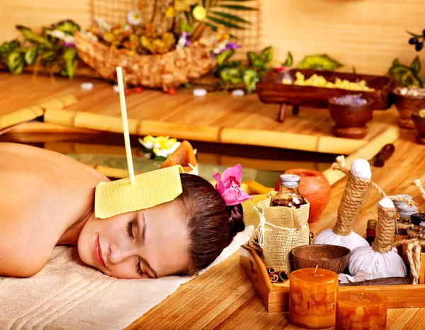 Woman getting massage with ear candle . Stock Picture