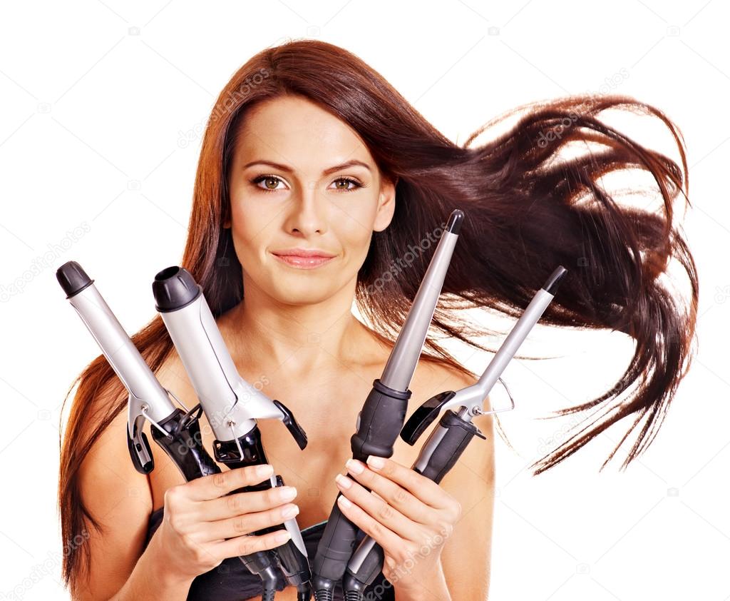 Woman holding iron curling hair.