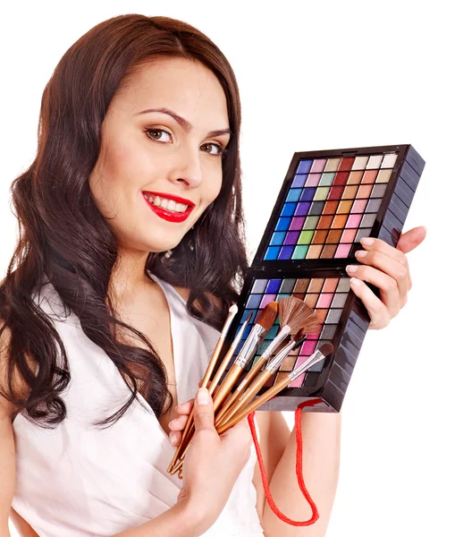 Girl holding eyeshadow and makeup brush. — Stock Photo, Image